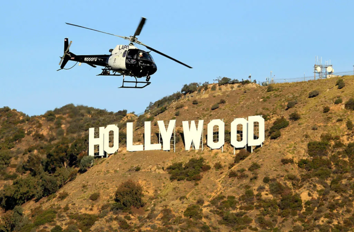Image of a police helicopter flying near the Hollywood sign.