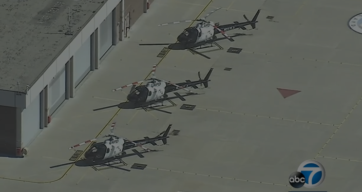 Image of 3 LAPD helicopters parked at a helipad.
